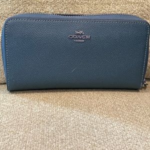 This is a dark green accordion wallet